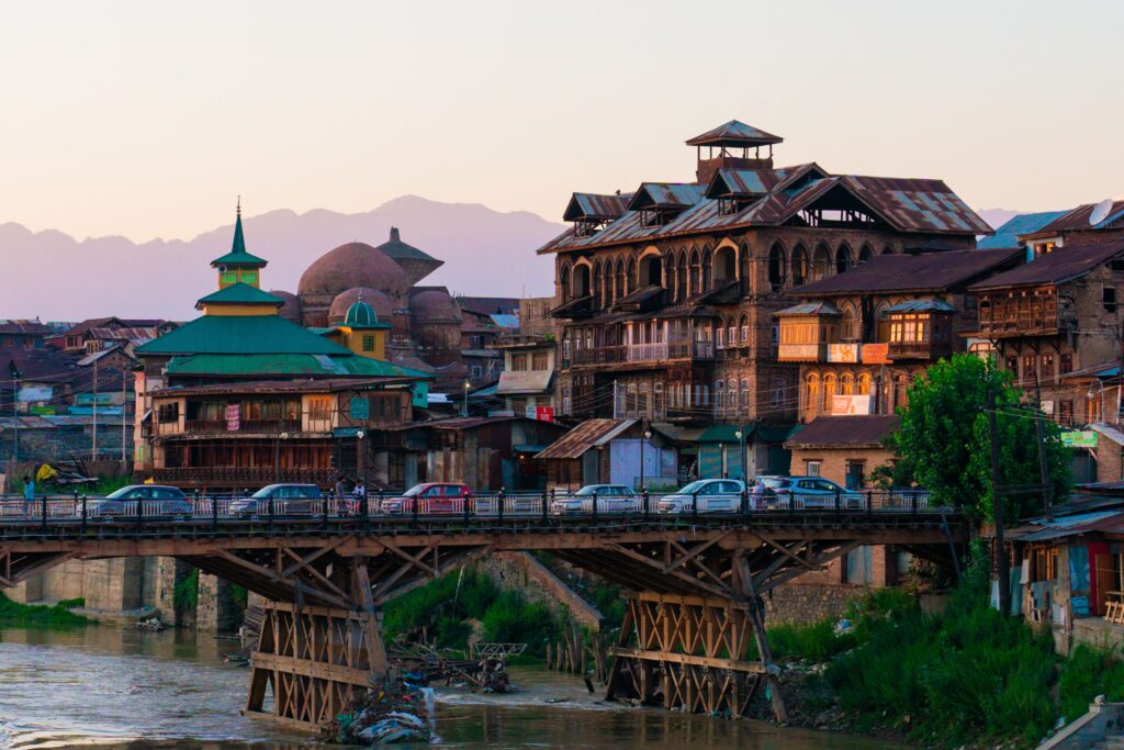 Historic wooden bridge, traditional Kashmiri architecture, and riverside cityscape in Srinagar, Kashmir, India.